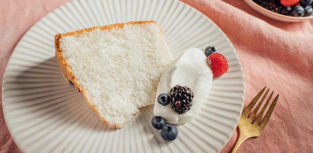 Fluffy Angel Food Cake with creamy topping and fresh berries