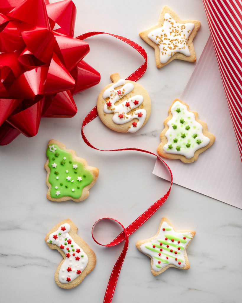 Holiday cookies frosted in white with red and green sugar and sprinkles
