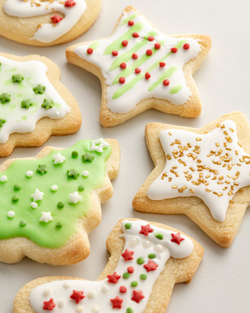 Holiday Cookies Made With Cake Flour, decorated with white frosting and red and green sugar and sprinkles