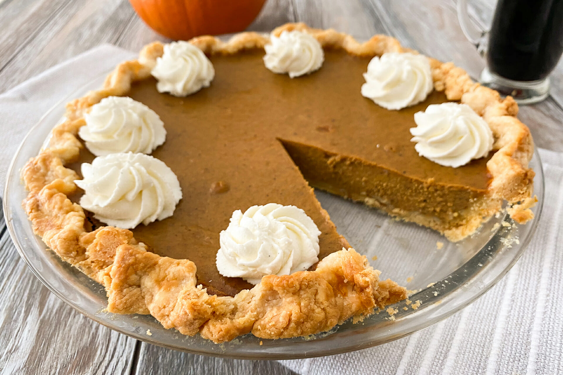 A Chai Spice Pumpkin Pie with a slice removed