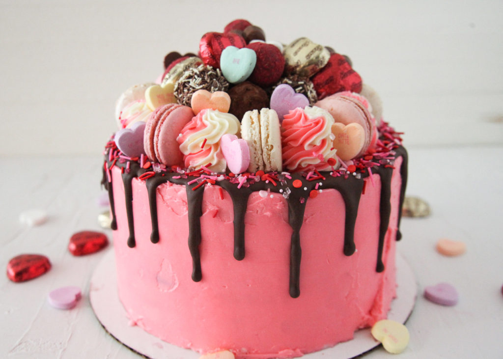 Pink Frosted Cake With Macaron Toppings