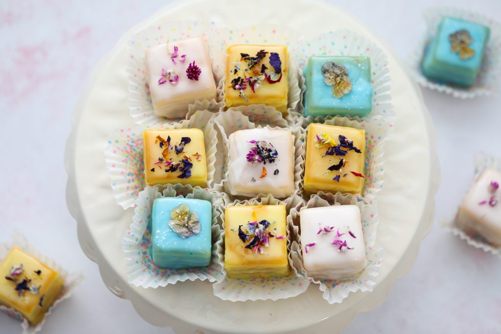 Small Frosted Cake Squares On A Cake Plate