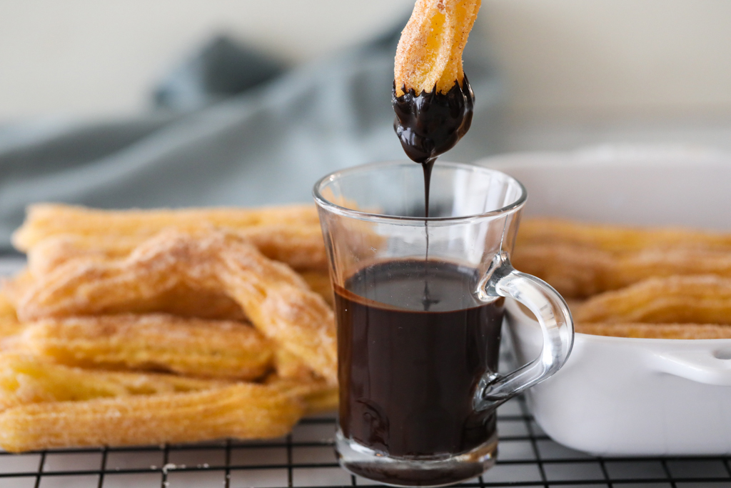 Dipping Churro Made With Cake Flour Into Chocolate