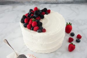 White Frosted Cake With Berry Topping