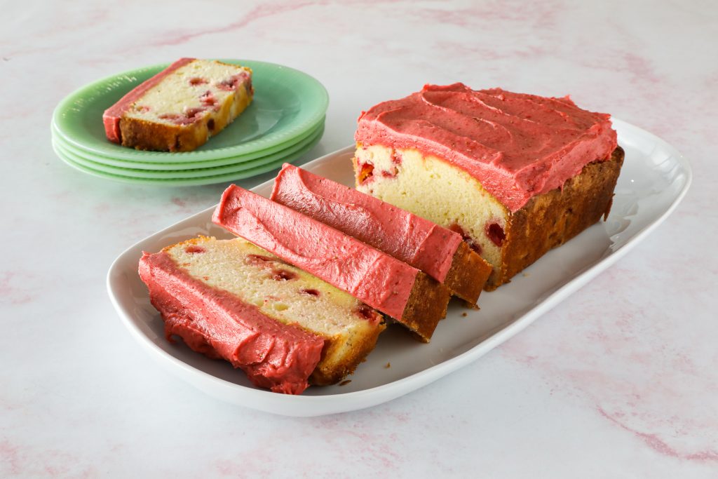 Strawberry Pound Cake with pink frosting, sliced on plate