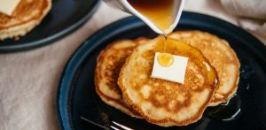 Pancakes on a plate with butter and syrup
