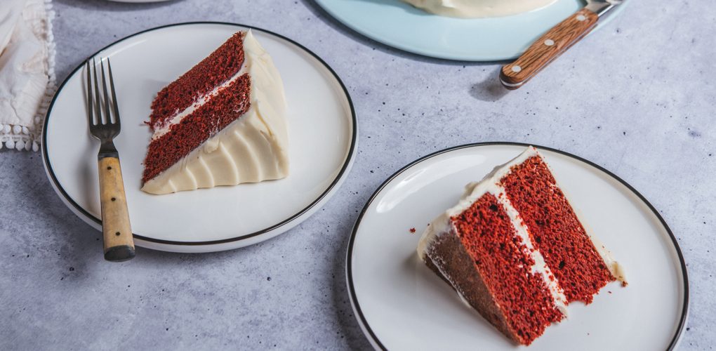 Slices of Red Velvet cake on serving plates