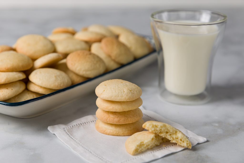 Homemade Vanilla Wafer cookies on serving platter with glass of milk