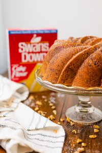 Whole Walnut Bundt Cake on cake stand with Box of Swans Down Cake Flour in background