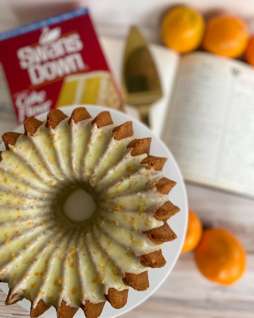 orange glazed bundt cake on cake stand