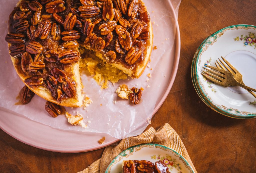 Pecan Upside-Down Cake on a pink serving platter