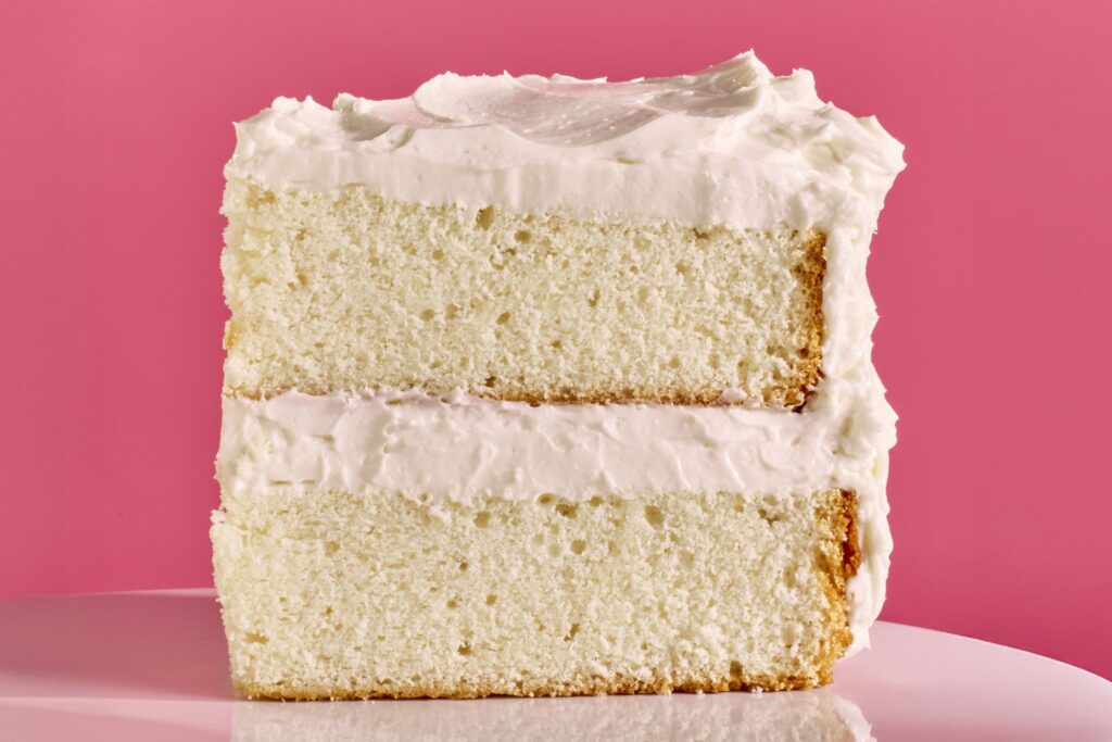Vintage white cake for weddings or any celebration, light and fluffy, one slice on a plate